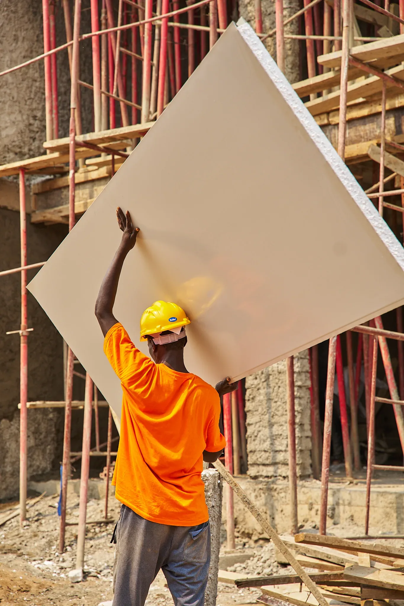 Two workers carrying a lightweight SPECO sandwich panel